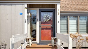 A building with a wooden door, a welcome sign, and a number 134 sign. - Amazing Lake Views! Close to Resort! Patio, Fireplace & Dog Friendly! (Galena)