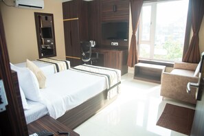 Relax in this stylish room with a large bed, sofa, and armchair, plus a flat-screen TV and desk for work or entertainment.