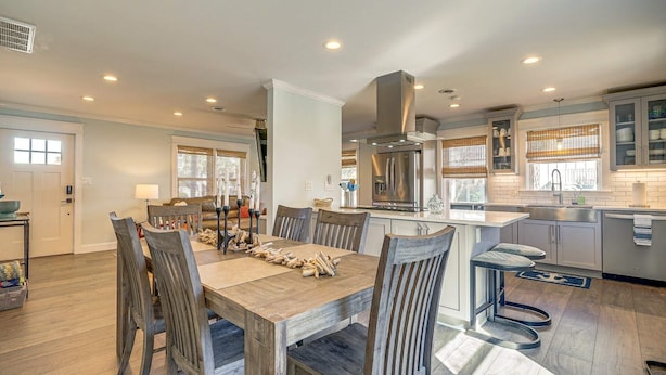 A spacious kitchen with a central island, modern appliances, and ample natural light. - Peaceful Getaway Close to Loop, Beach, Dining (Wrightsville Beach)