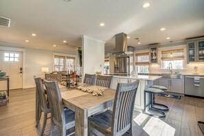A spacious kitchen with a central island, modern appliances, and ample natural light.