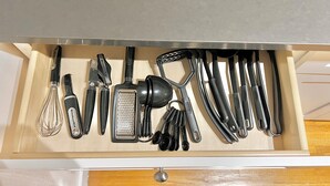 A drawer containing various kitchen utensils including whisks, a grater, and a peeler. - Large and Rare 4-bedroom apartment in amazing New York with WiFi, AC (New York)