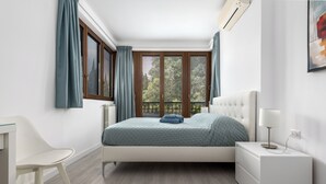 A bedroom with a bed, bedside table, chair, and a window with curtains. - La Casa del Tomo - Metro A - Private Parking - 6 Guests (Roma)