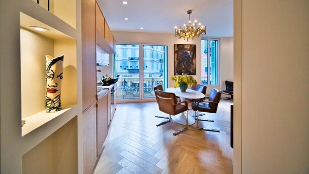 A modern kitchen with a dining area, large windows, and a chandelier. - Port of Nice - Scooters Included (Nice)