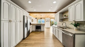A modern kitchen with white cabinetry, a wooden ceiling, and a central island. - Newly Remodeled Mountain Cabin w/ Epic Views, A/C, Optional Hot tub, 2 Kitchens (Durango)