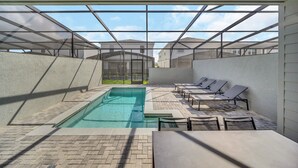 A modern indoor pool area with a clear view of the sky and surrounding buildings. - Mickey Slide • Avengers Room • Star Wars Game Room • Private Pool (Clermont)