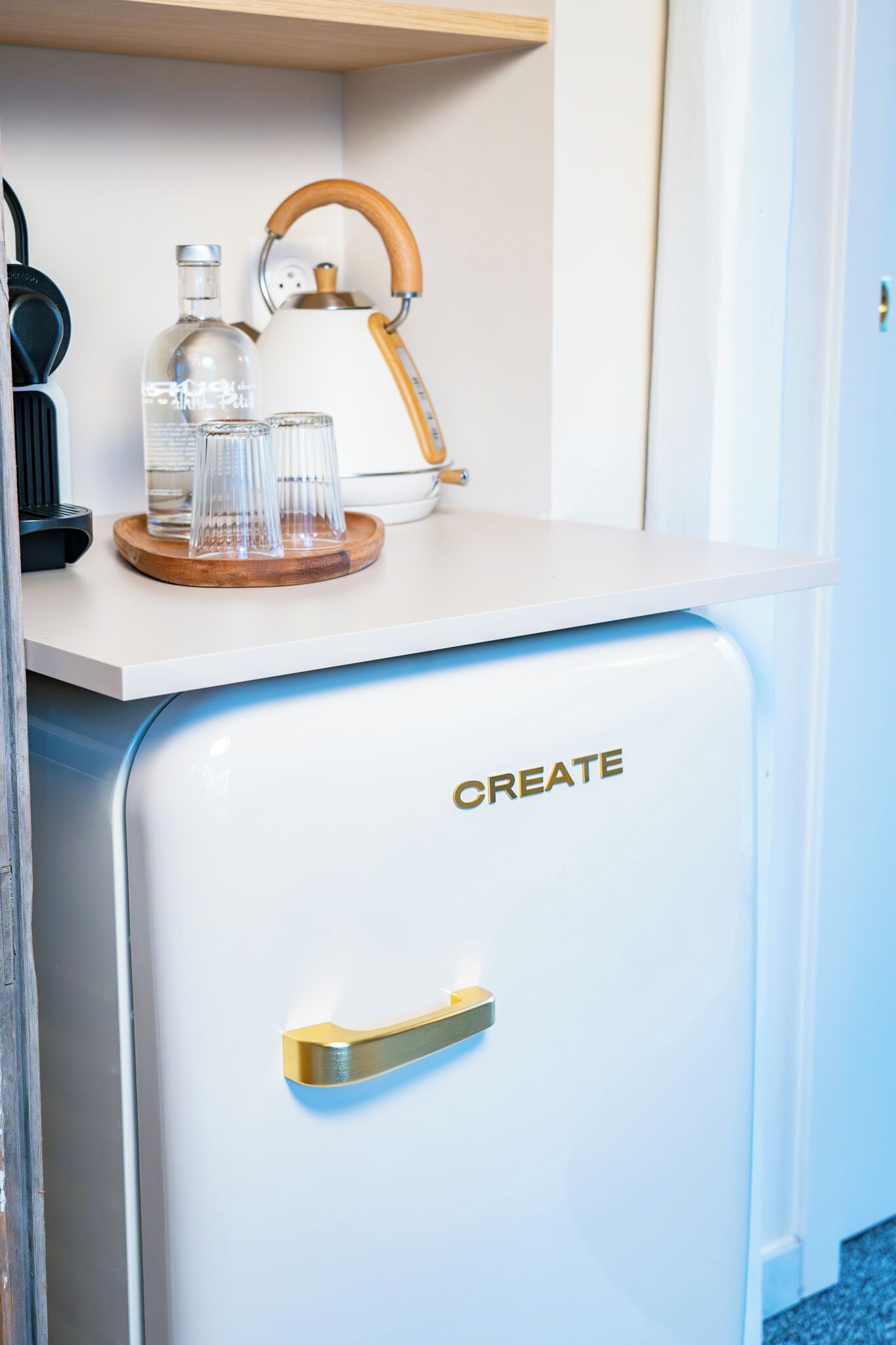 A vintage-style refrigerator with a handle and the word "CREATE" on it.