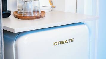 A vintage-style refrigerator with a handle and the word "CREATE" on it.
