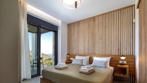 A modern bedroom with a large bed, wooden headboard, and a view of the outdoors. - Agapanthus Ultimate Luxury Villa (Likotinarea)