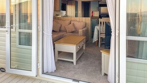 A cozy interior with a sofa, a small table, and a chair. - 3 bedroom accommodation in Lancaster (Lancaster)