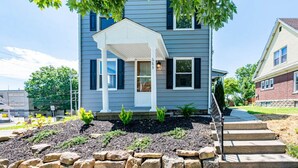 A two-story house with a covered porch and a well-maintained front yard. - Beautiful 3 Bedroom Downtown Salem Home (Salem)