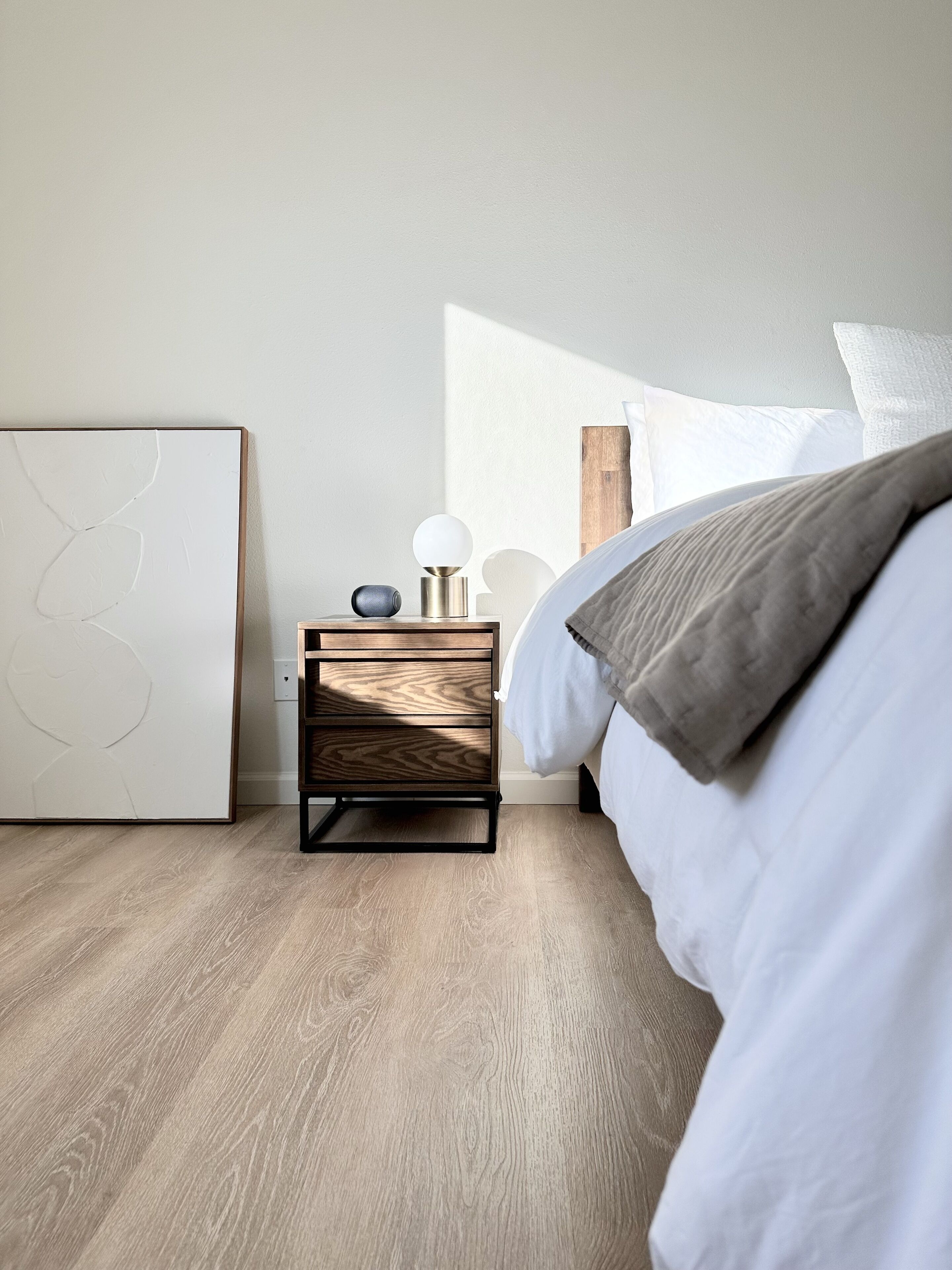 Fine furnishings, curated art, and a Bluetooth speaker for a relaxing retreat.