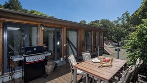 A wooden deck with a grill, dining table, and chairs. - Luxurious sandstone villa - 320 sqm - 7 rooms (Dresden)