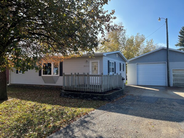A single-story house with a front porch, a garage, and a small deck. - Private Lakeside Escape on Devils Lake  (Devils Lake)