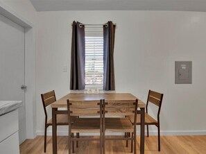 Enjoy meals in this cozy dining area with a wooden table and four matching chairs.