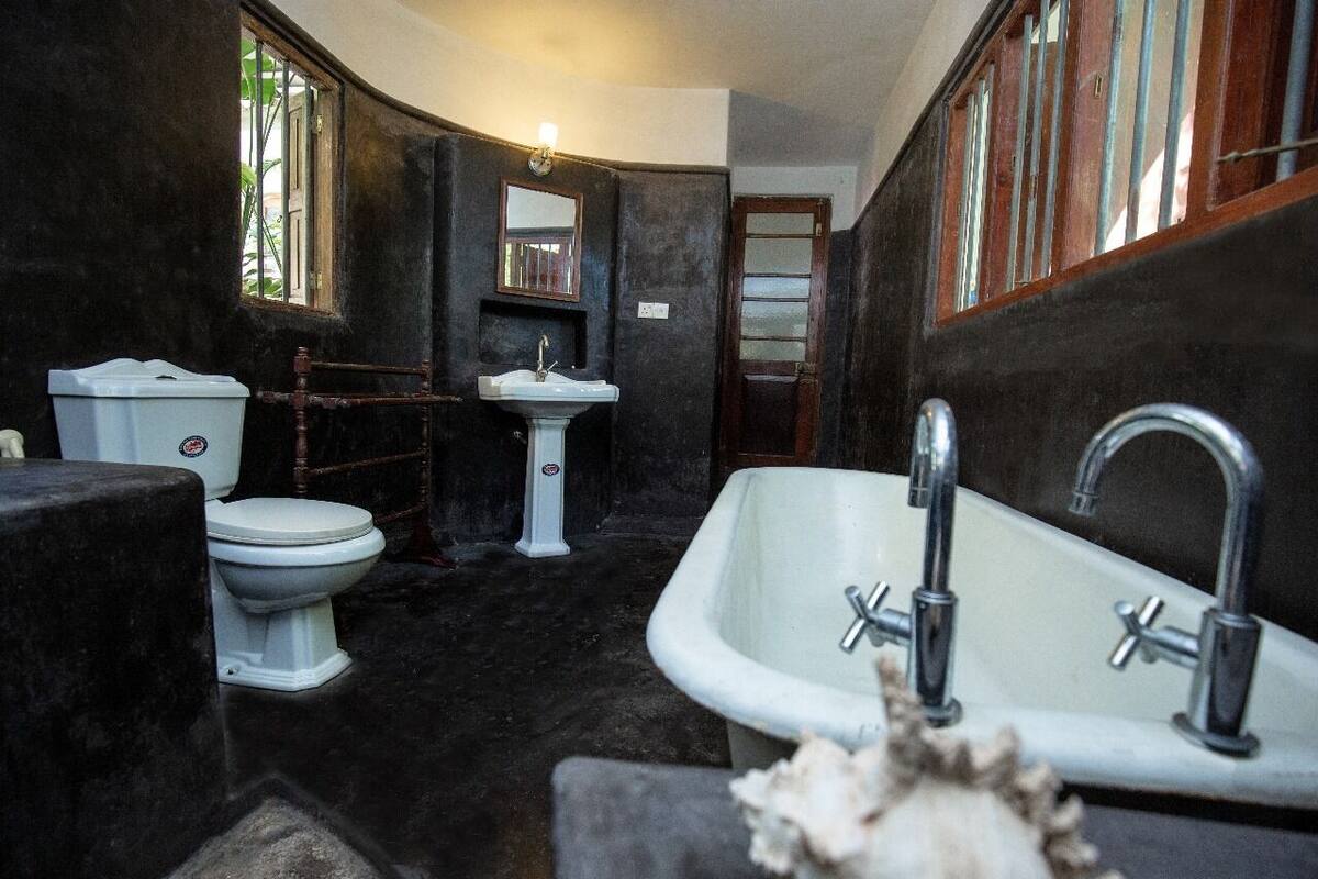A compact bathroom with a white toilet, a sink, and a bathtub.