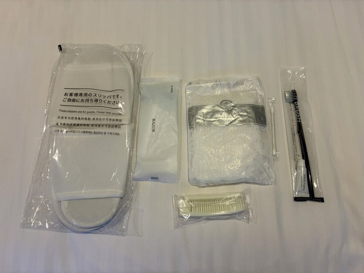 A set of toiletries including a toothbrush, toothpaste, and a comb, all packaged in clear plastic.
