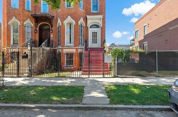 Classic two-story building with a prominent entrance and well-manicured lawn.