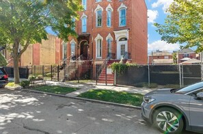 Classic two-story building with a prominent entrance and a tree-lined setting.