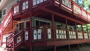 A two-story building with a red exterior and multiple windows. - 1st Floor - 1 mile from San Moritz Lodge (Crestline)