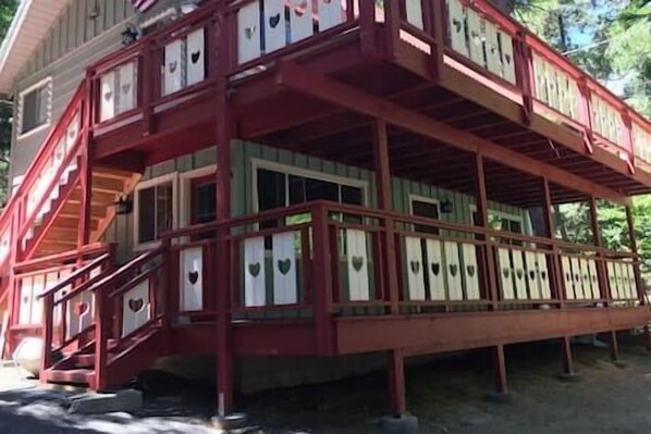 A two-story building with a red exterior and multiple windows.