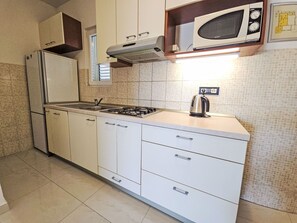 Fridge, microwave, cookware/dishes/utensils