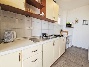 Fridge, microwave, cookware/dishes/utensils