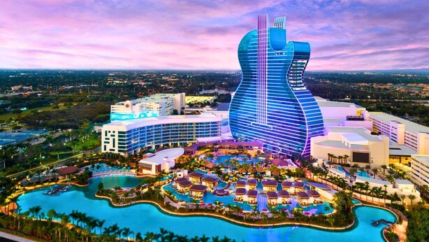 A resort with a distinctive guitar-shaped building, multiple swimming pools, and a variety of resort buildings. - Waterfront | Boat Rental | Heated Pool | Games Room | Sleeps 8 (Lighthouse Point)