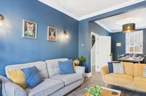 Relax in this stylish living room with two sofas, a coffee table, and a dining area.