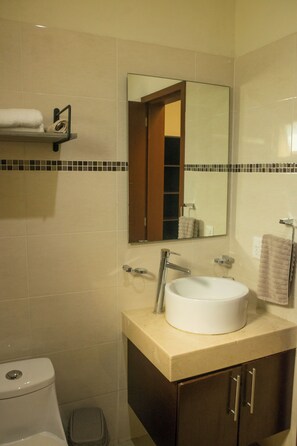 A bathroom with a white sink, a mirror, a towel rack, and a toilet. - Tropical Getaway in Flamingos near Beach (Bucerías)