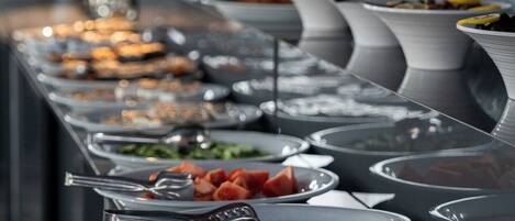 Un buffet proposant une variété de plats et d’ustensiles.