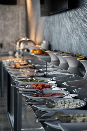 A buffet line with various food items and utensils. - Saffari Hotel (Ankara)