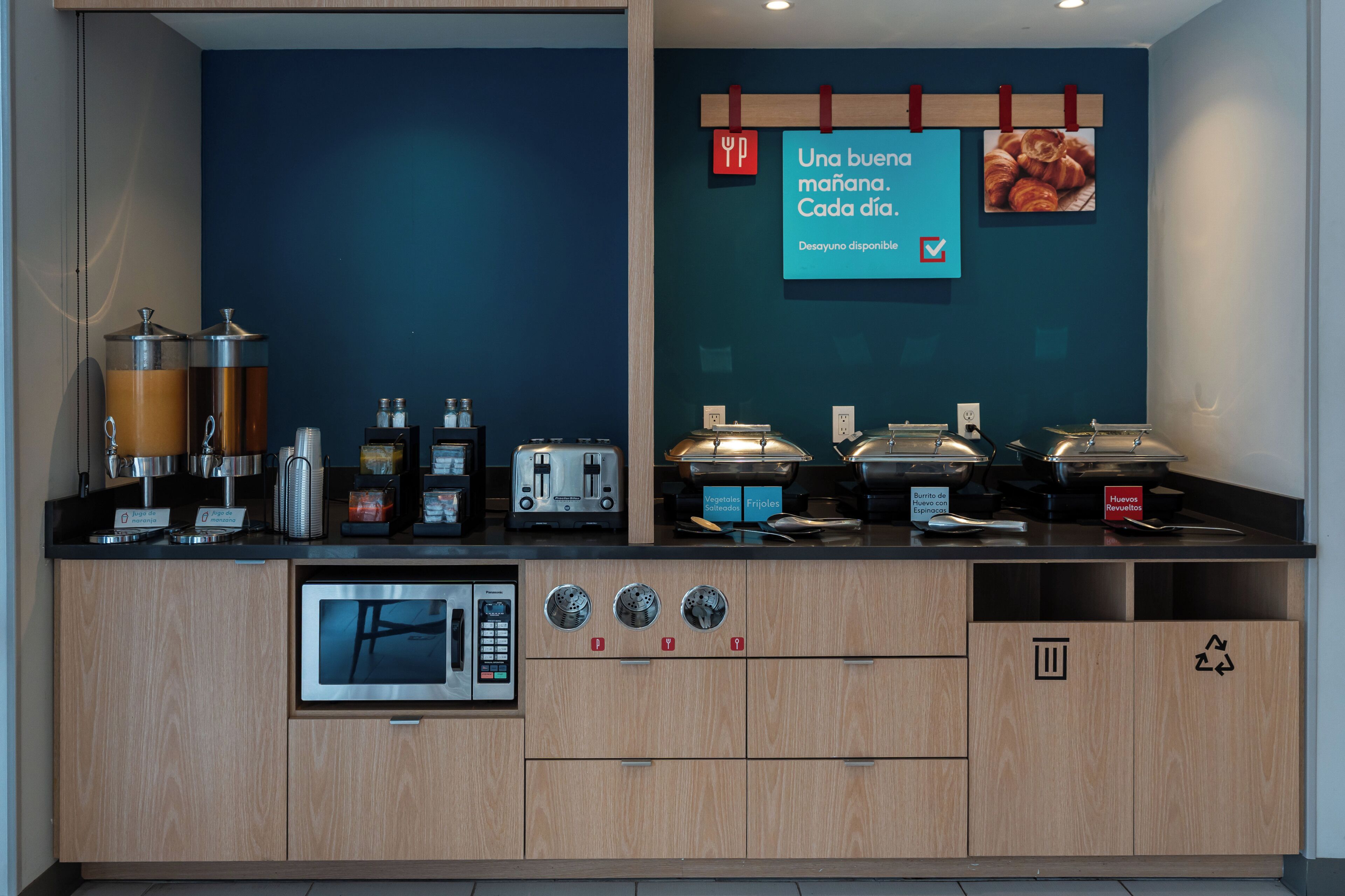 A kitchenette with coffee machines, a microwave, and a coffee station.