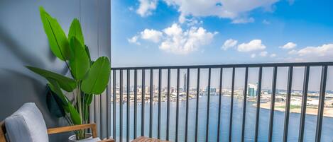 A balcony with a view of a cityscape and water.