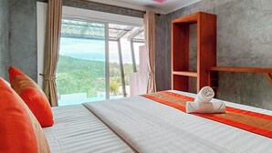 A hotel room with a large bed, a wooden shelf, and a view of the outdoors. - PhuLanta Resort (Ko Lanta)