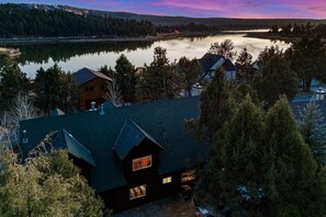 A lakeside property with multiple cabins, surrounded by dense forest and a calm lake.