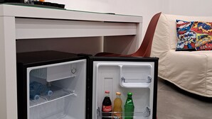 A compact refrigerator with a freezer compartment, a microwave, and a small coffee maker on top. - Napolitan Pop House (Naples)