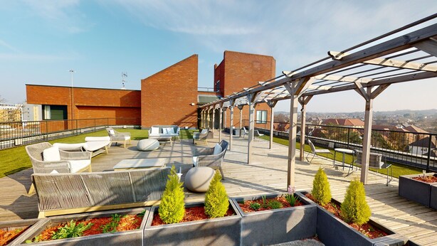 A rooftop terrace with outdoor seating, a pergola, and a view of the cityscape. - Luxury Apartment - Town Centre North Stevenage (Stevenage)