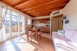 Basic Apartment | Living area | 35-cm TV with digital channels - Borgo del Torchio A14 by Wonderful Italy (Manerba del Garda)