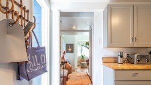 A kitchen with wooden cabinets, a countertop, and a coffee maker.