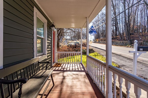 A porch with a white railing, a bench, and a house number 17. - Cozy Easy Access to the Best of the Hudson Valley (Cornwall)