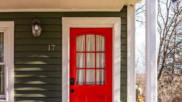 A green house with a red door, white porch railing, and a number '17' on the wall. - Cozy Easy Access to the Best of the Hudson Valley (Cornwall)