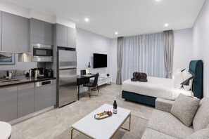 Enjoy a comfortable stay in this well-appointed room featuring a compact kitchenette, seating area, and flat-screen TV.