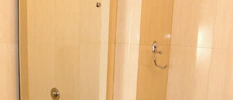A bathroom with a sink, mirror, and shower.