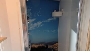 Shower, hair dryer, soap, toilet paper
