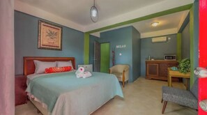 Relax in comfort with a large bed, wooden headboard, and plush furnishings.