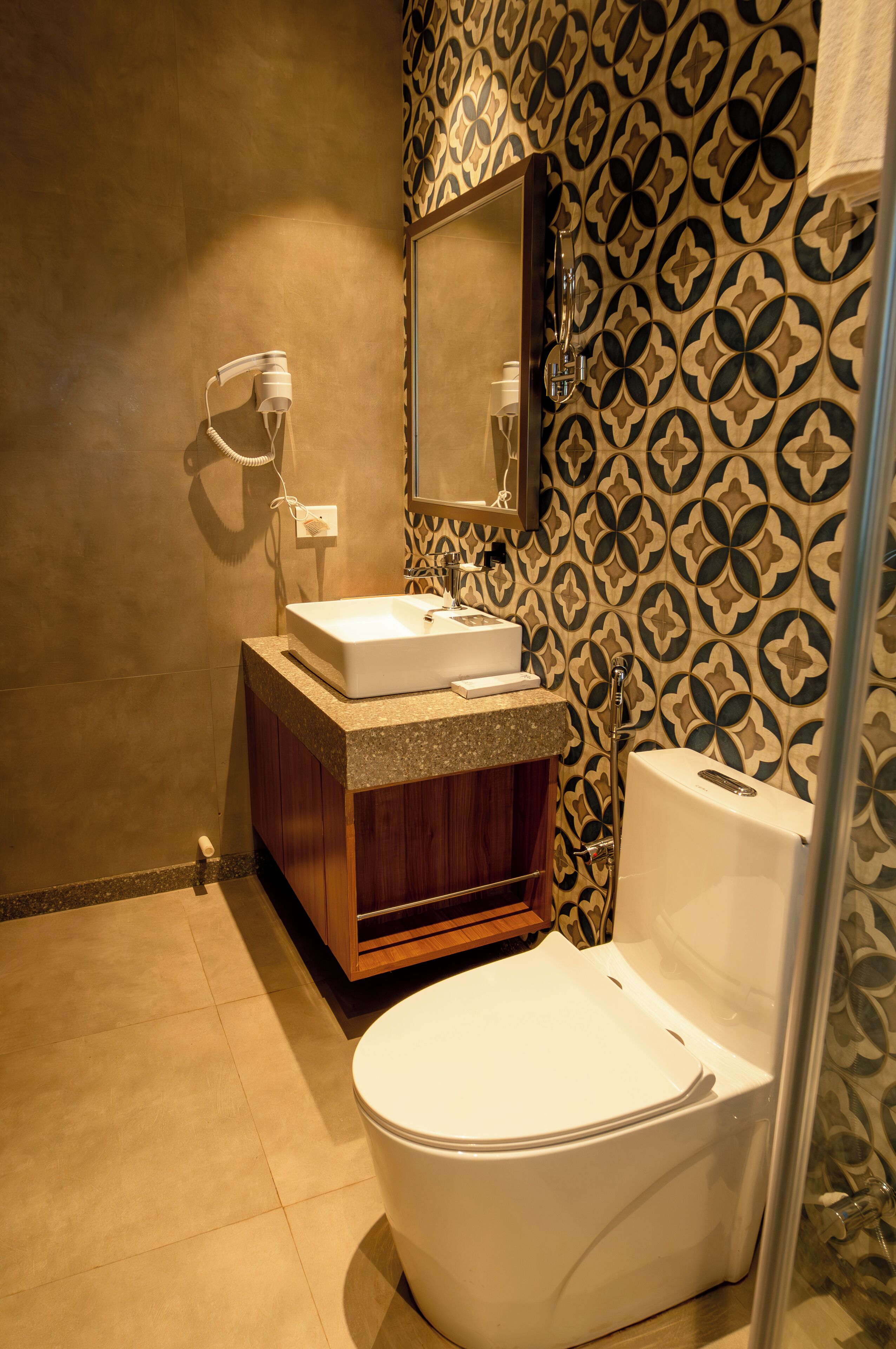 Un baño con lavamanos, espejo e inodoro.