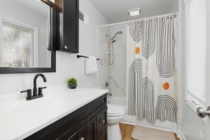 Jetted bath, hair dryer, towels, toilet paper