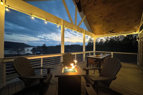 Main level balcony accompanied by a firepit & large outdoor dining table!