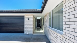 A modern building with a garage, a narrow hallway, and a large window.