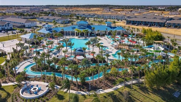 An aerial view of a resort with multiple swimming pools, palm trees, and a variety of buildings. - Unrivaled Amenities Unforgettable Comfort Await (Davenport)